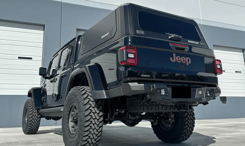 Lifted black Jeep with off-road tires and custom suspension outside The Custom Shop LV