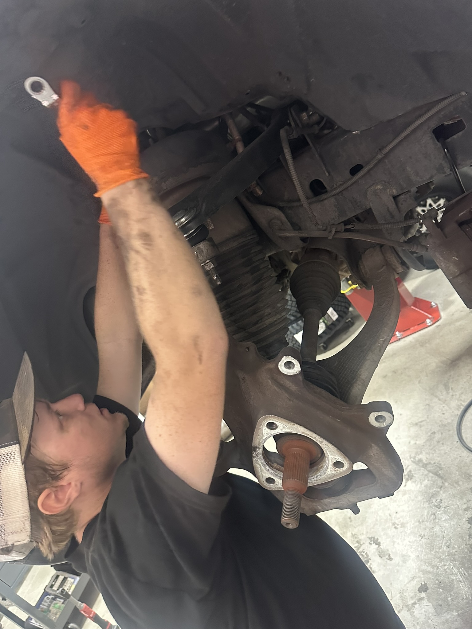 Technician removing factory air suspension from the Ram front wheel well
