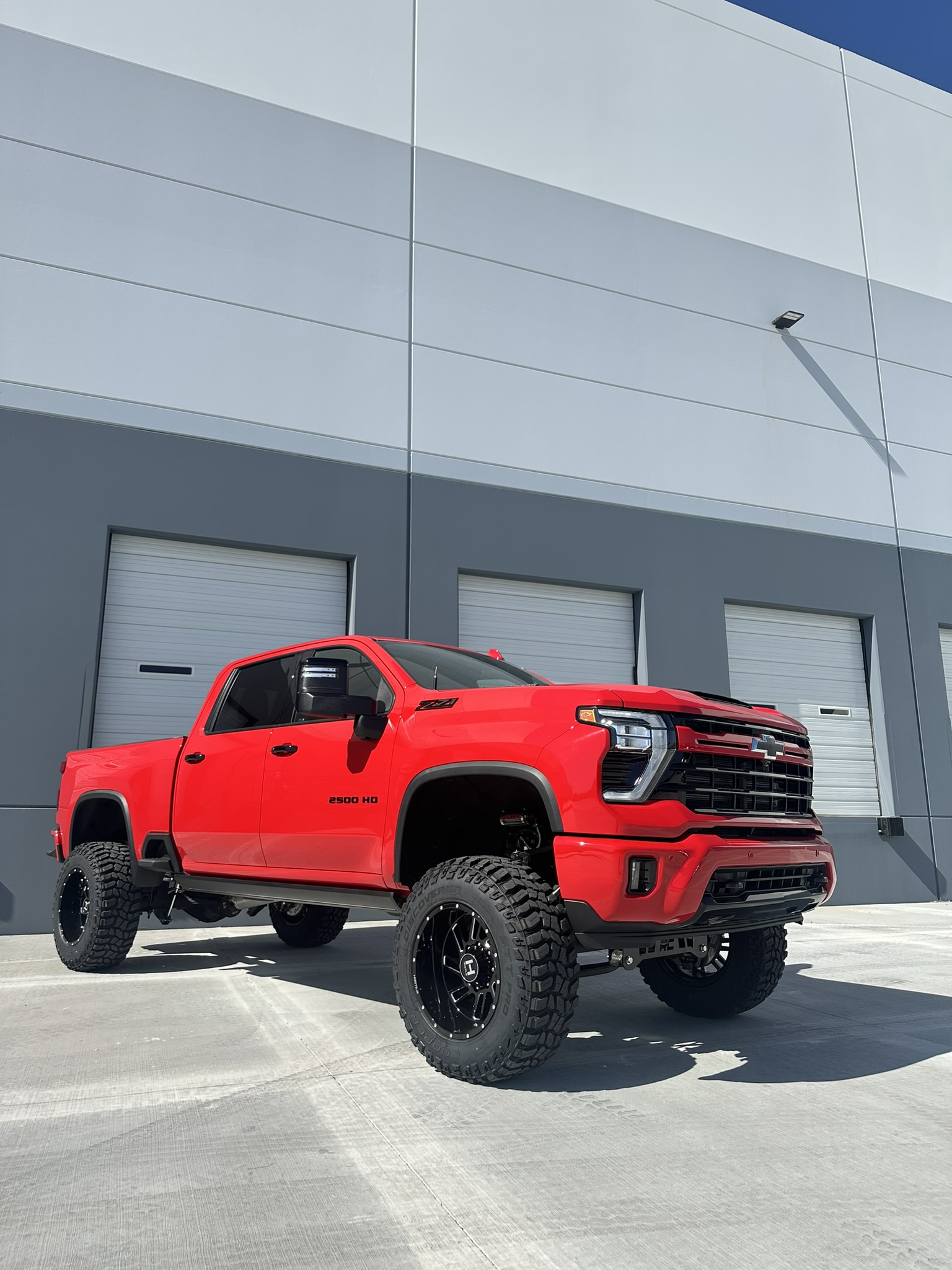 Low-angle view of the finished lifted Silverado 2500HD