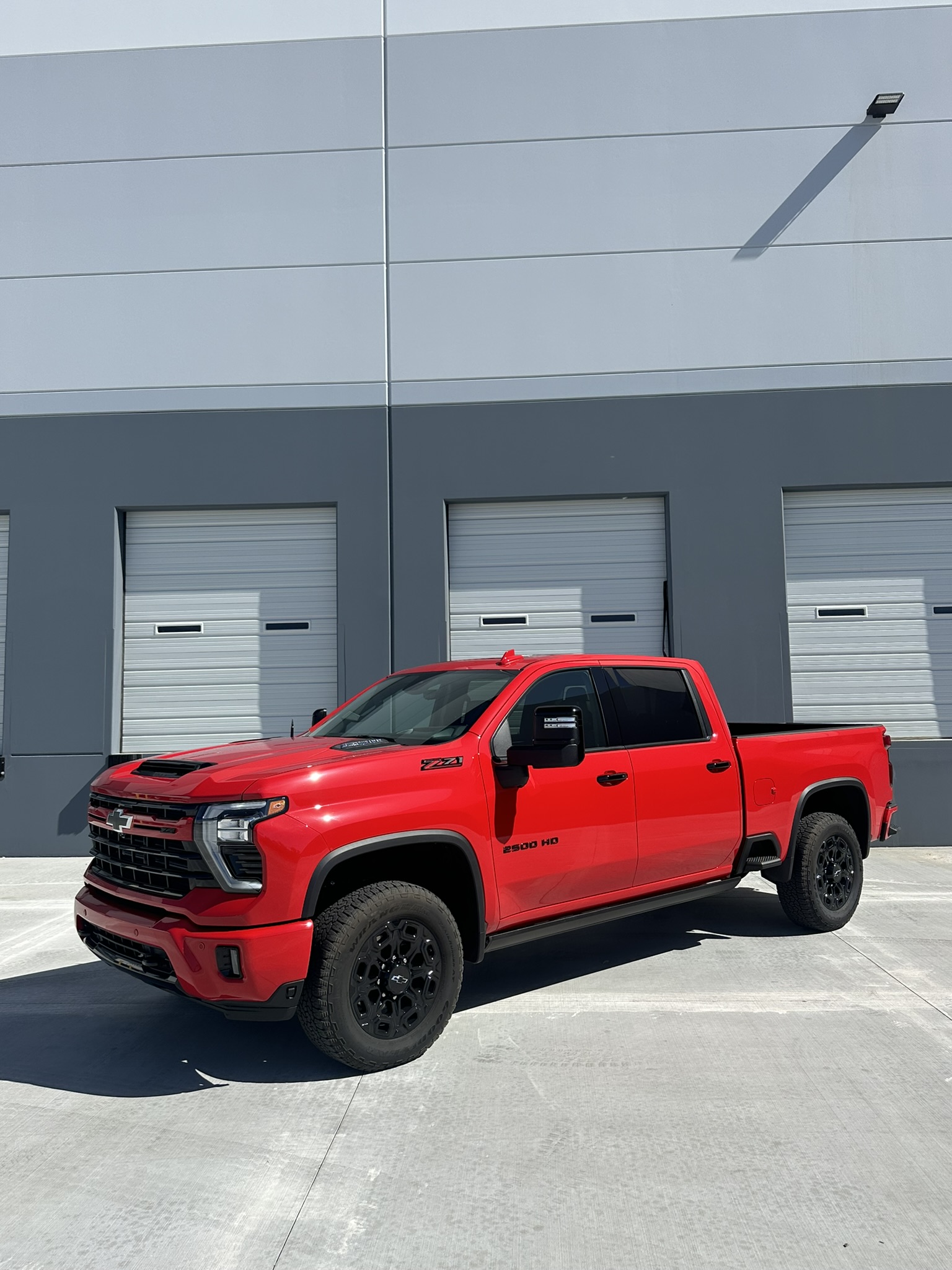 Front three-quarter view of the red Silverado 2500HD before its transformation