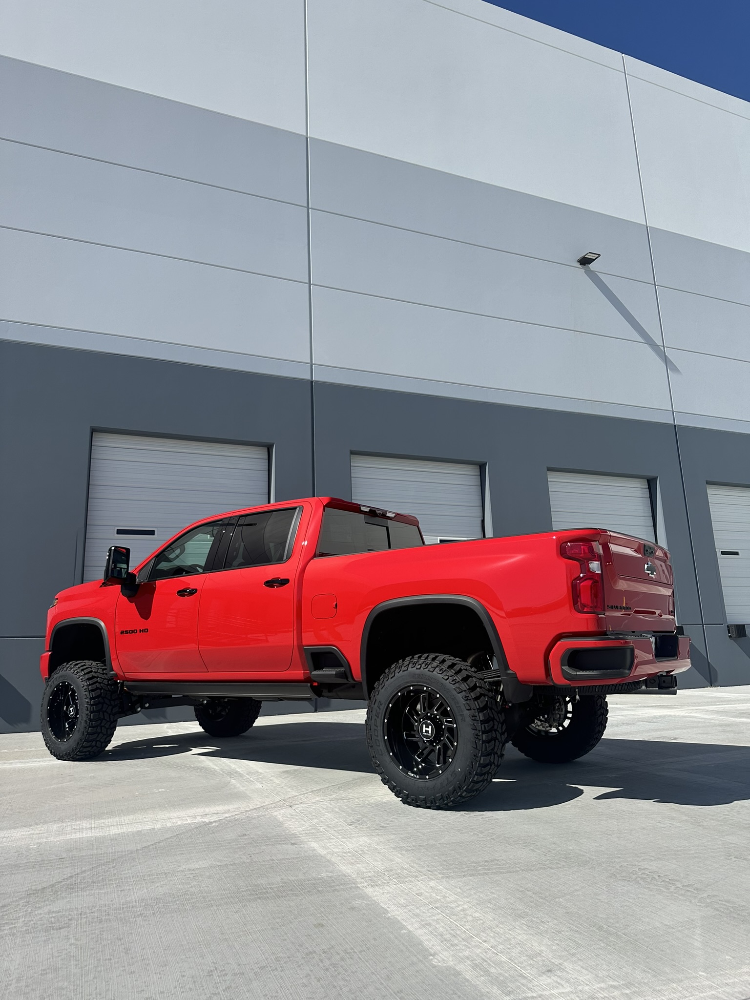 Rear three-quarter view of the completed lifted Silverado 2500HD