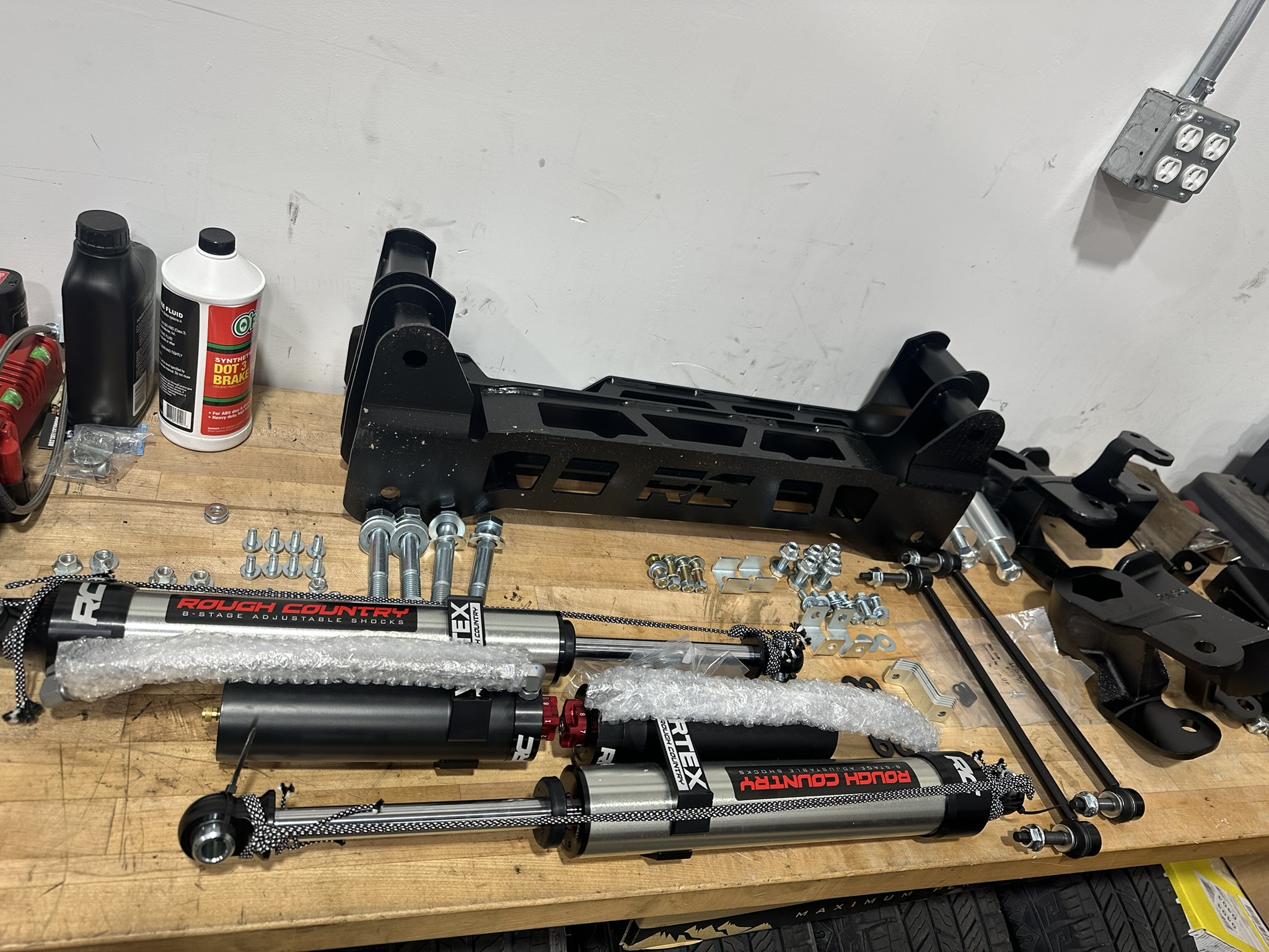 Rough Country suspension components and Vertex shocks arranged on a workbench