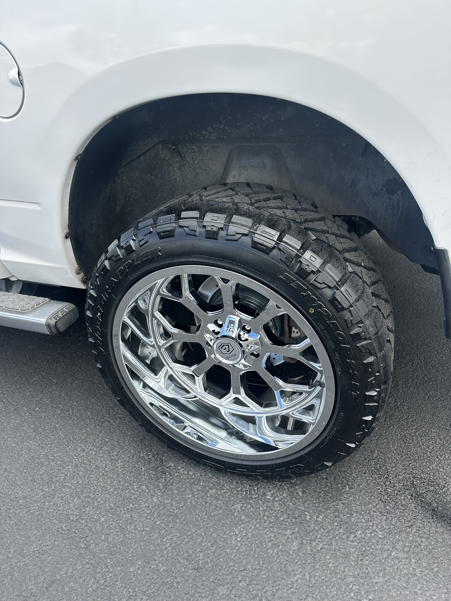 Finished rear chrome wheel and Nitto tire with drilled-and-slotted brake rotor visible