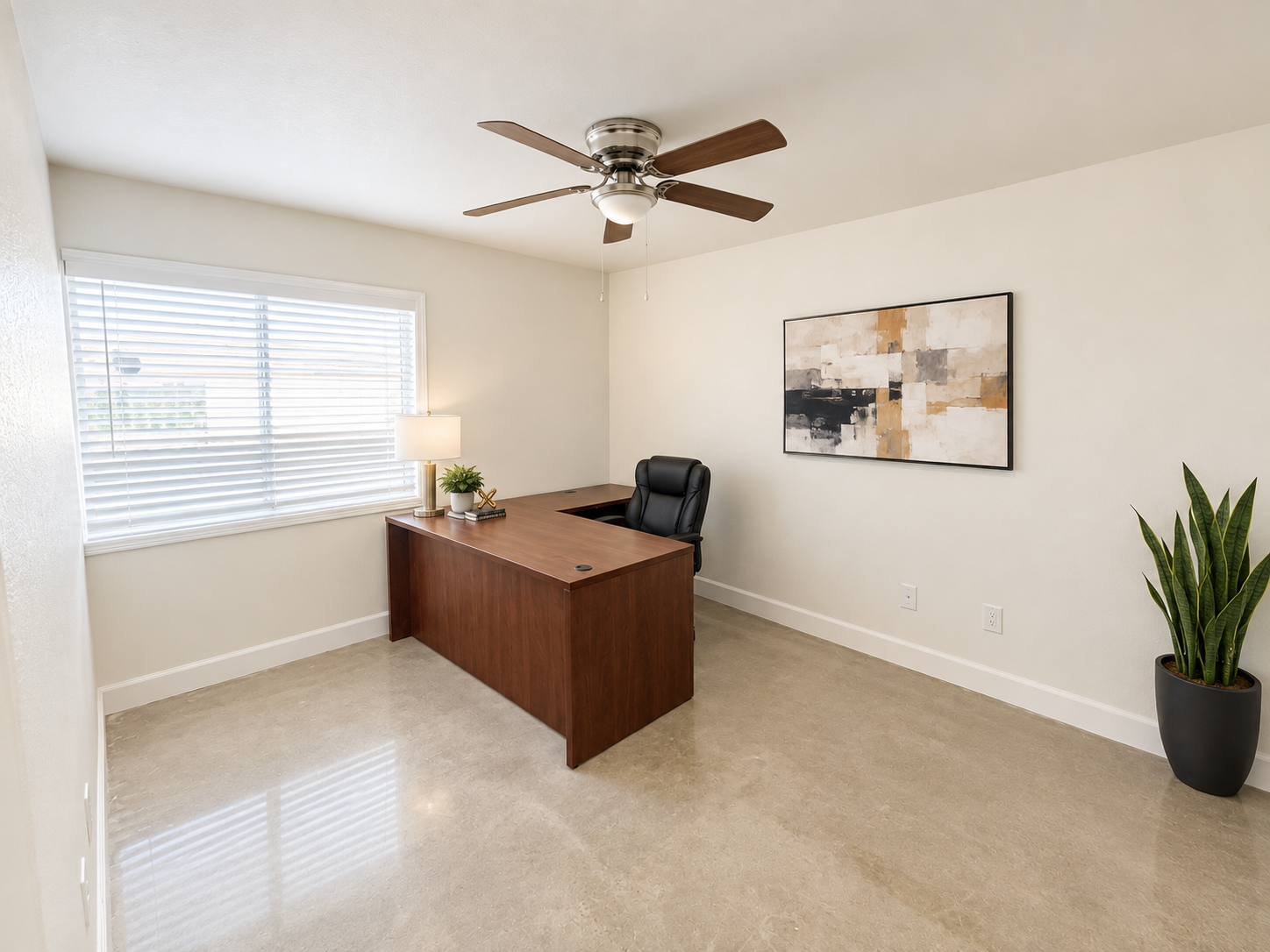Side perspective showing the spacious furnished workspace