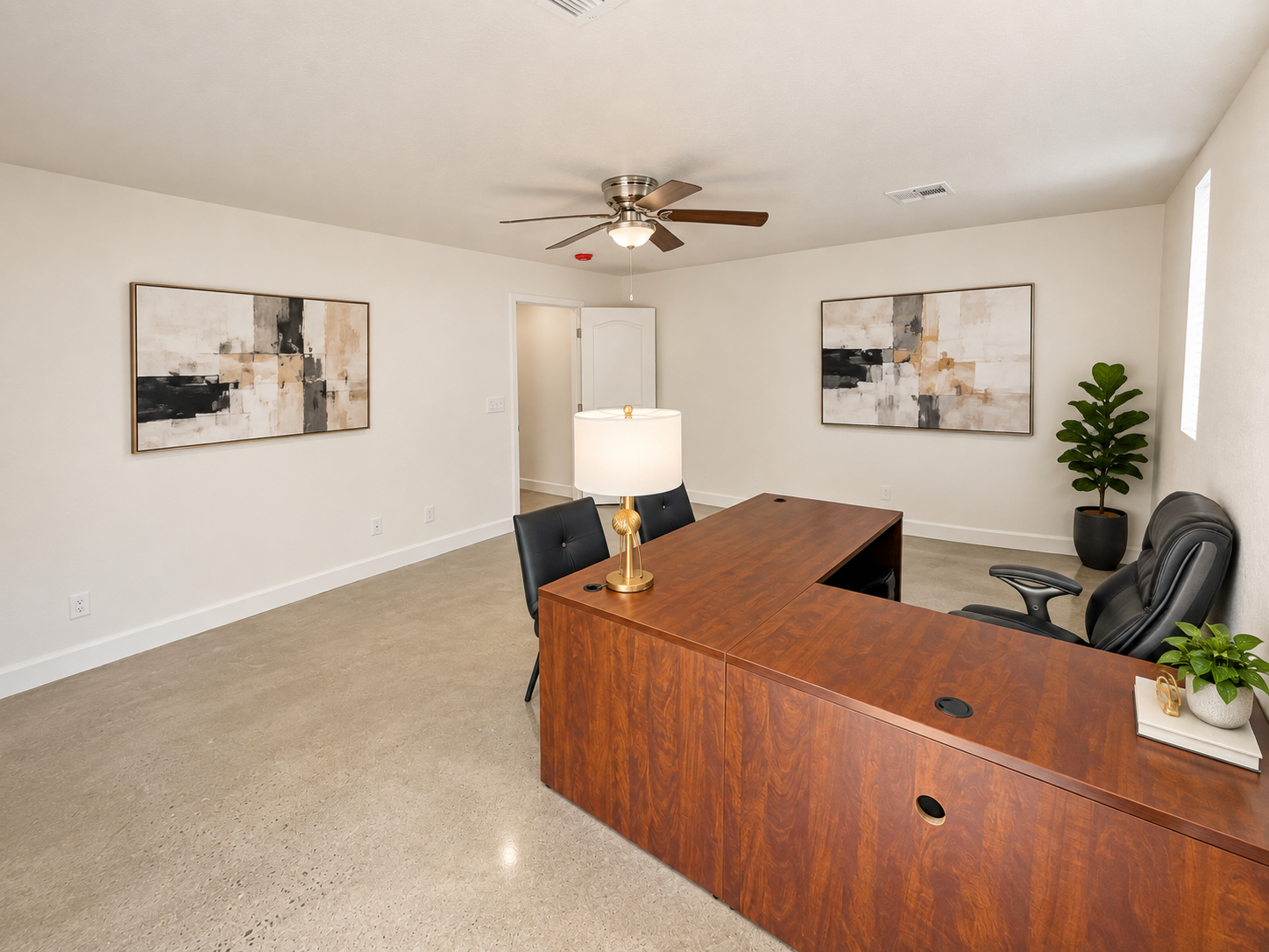 Side perspective showing the spacious furnished workspace and clear movement around the desk.